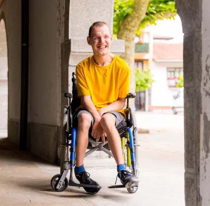 Disabled man in wheelchair smiling at camera