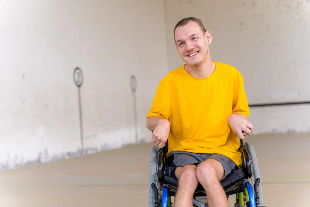 Disabled man in wheelchair smiling at camera