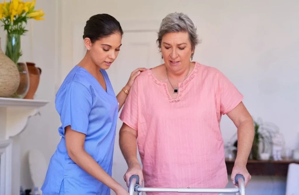 Nurse in home with older participant assisting with walking